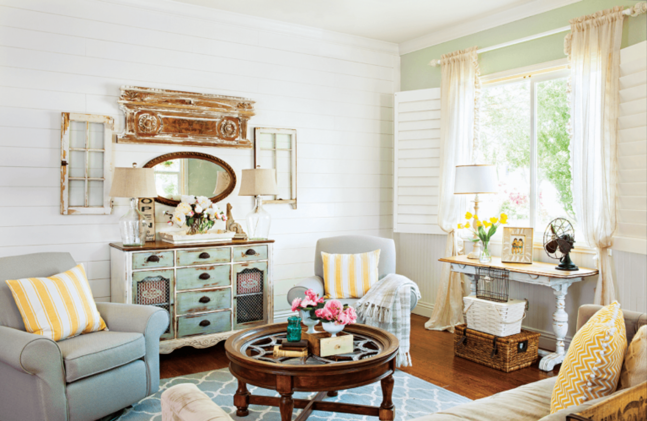 Cozy living room with window light comfy chairs and vintage coffee table.