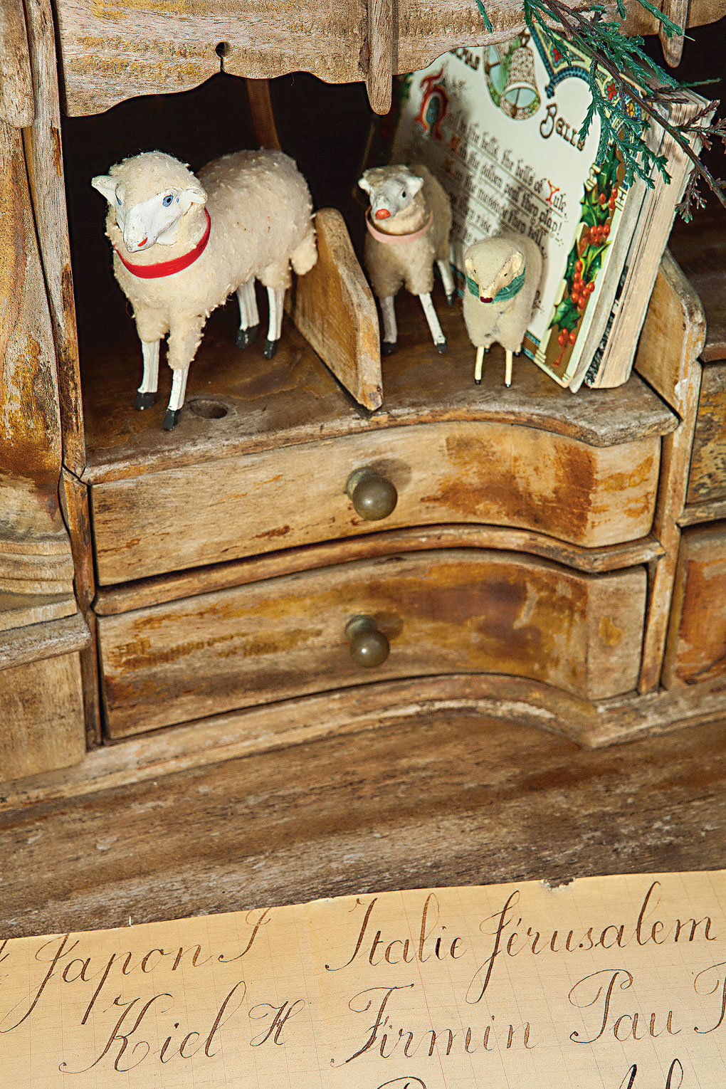 Vintage cabinet decorated with German Putz Sheep and Christmas postcards. 