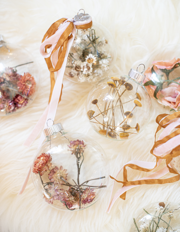 clear christmas tree ornaments filled with dried flowers