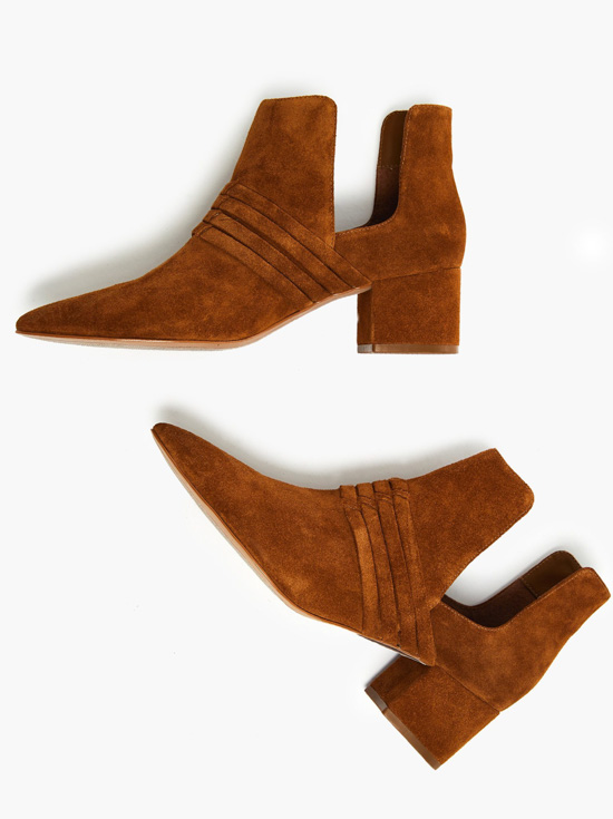 Tobacco colored suede booties with unique detailing and side cutouts.