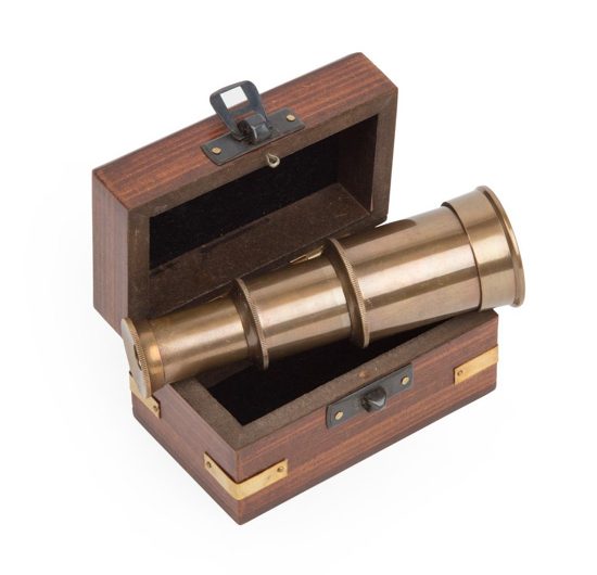Small wooden box with metal accents that stores an extendable mini telescope.