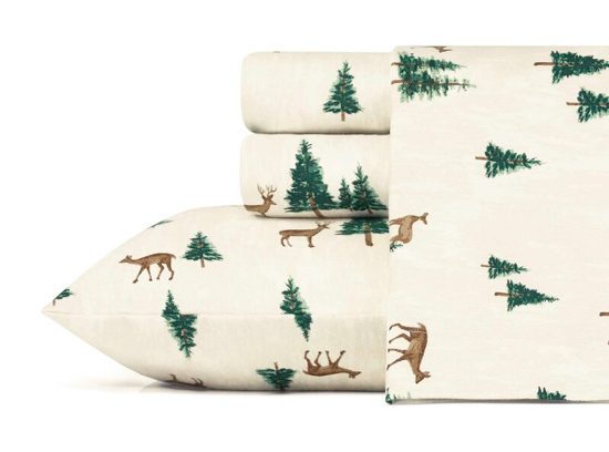 Cream colored flannel sheet set with roaming deer and pine trees.
