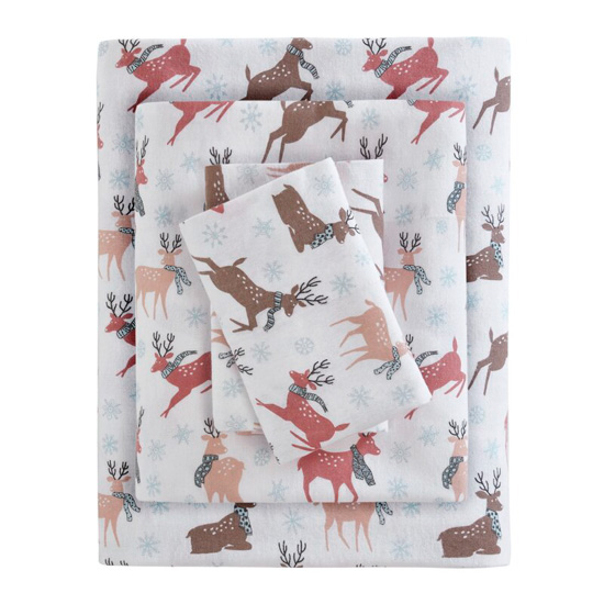 Stack of white flannel sheets covered in muted colored coral, brown and peach reindeers wearing scarves and prancing around. 