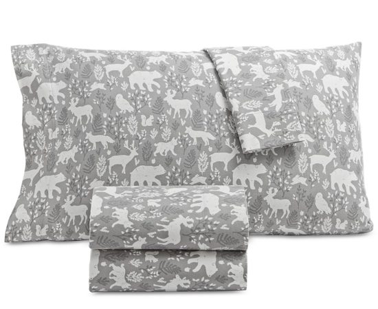 Gray flannel sheets covered in white woodland silhouettes. 