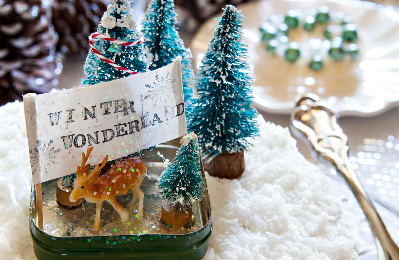 small green vintage tin filled with mini bottle brush trees and tiny deer