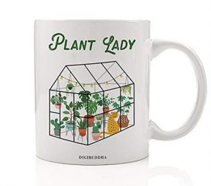 White ceramic mug with green house and "plant lady" decorated on one side.