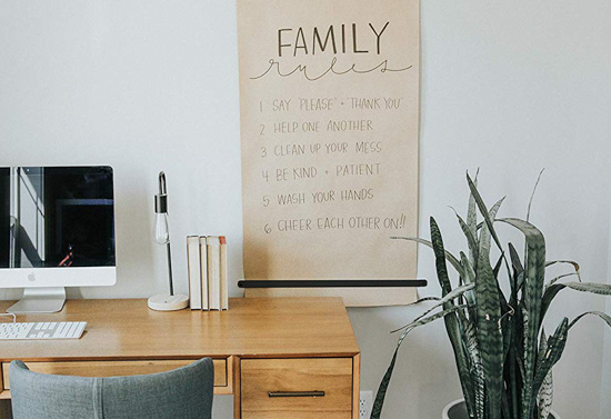 Minimalist office space featuring a roll of Kraft paper mounted on the wall.