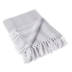 Gray and white herringbone throw blanket with fringed edge.