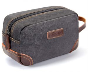 Grey canvas toiletries bag with brown leather accents.