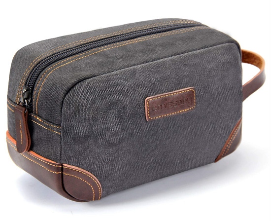 Grey canvas toiletries bag with brown leather accents. 