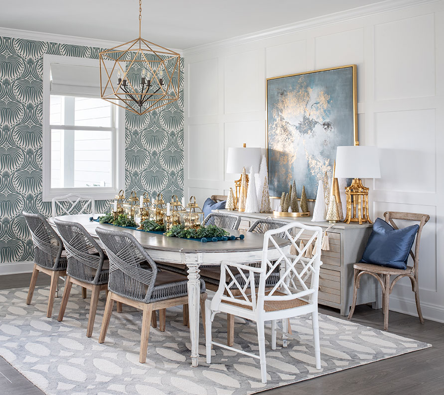dining room with a traditional table and a mix of modern and chippendale style chairs. Blue wallpaper on one wall.