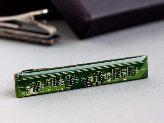 Tie clip made of bright green computer chip elements. 