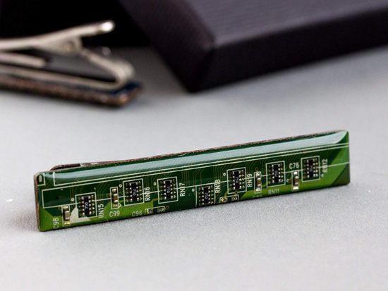 Tie clip made of bright green computer chip elements.