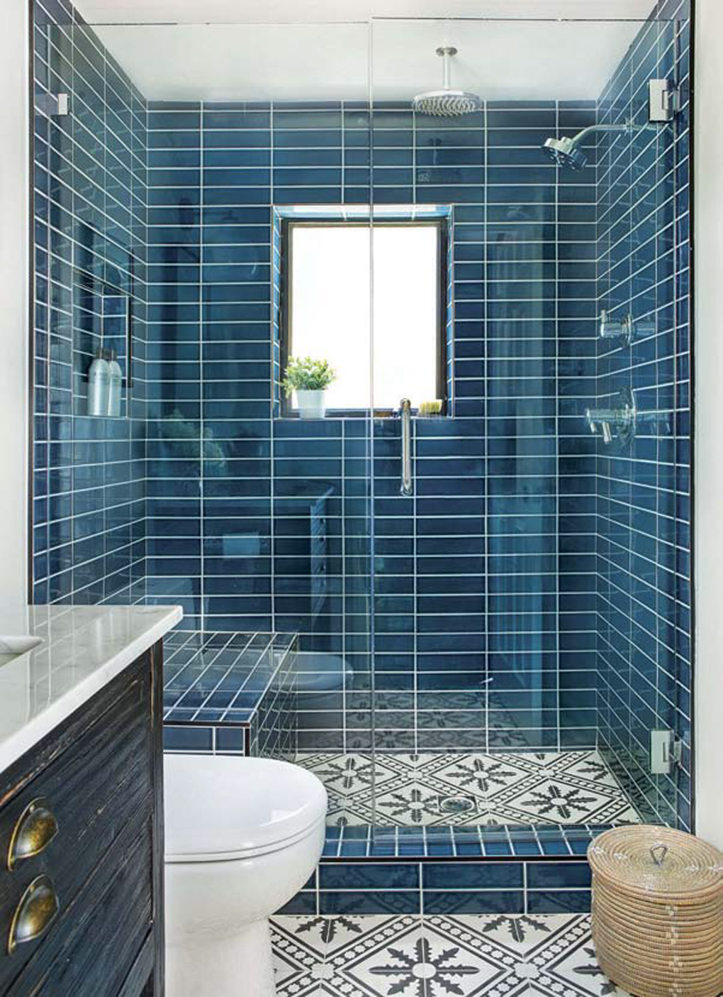 California cottage with a brightly lit large shower fully tiled in teal rectangle tiles with ornate flooring. 