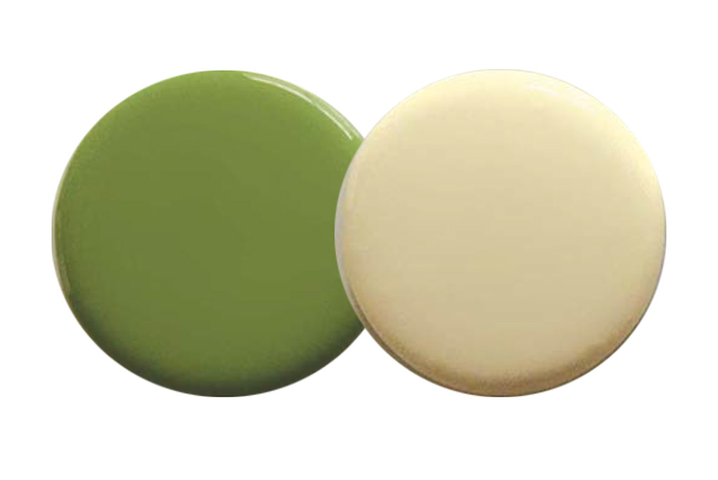 Two paint spots in buttercream and green.