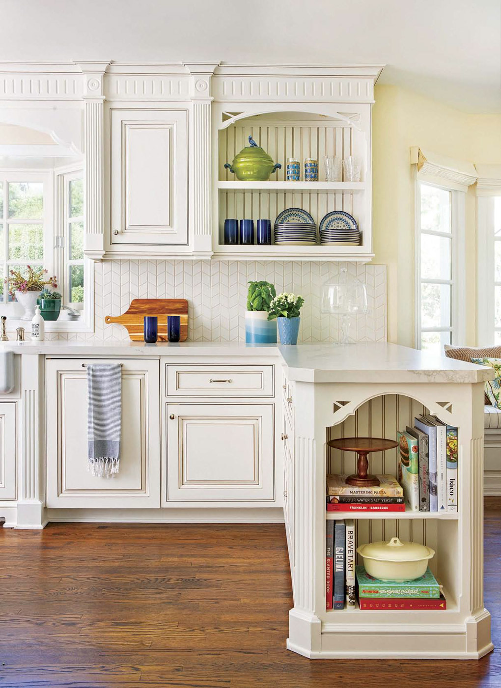 Kitchen update with cream colored custom open shelving and storage nook at the end of the countertop with blue accents. 