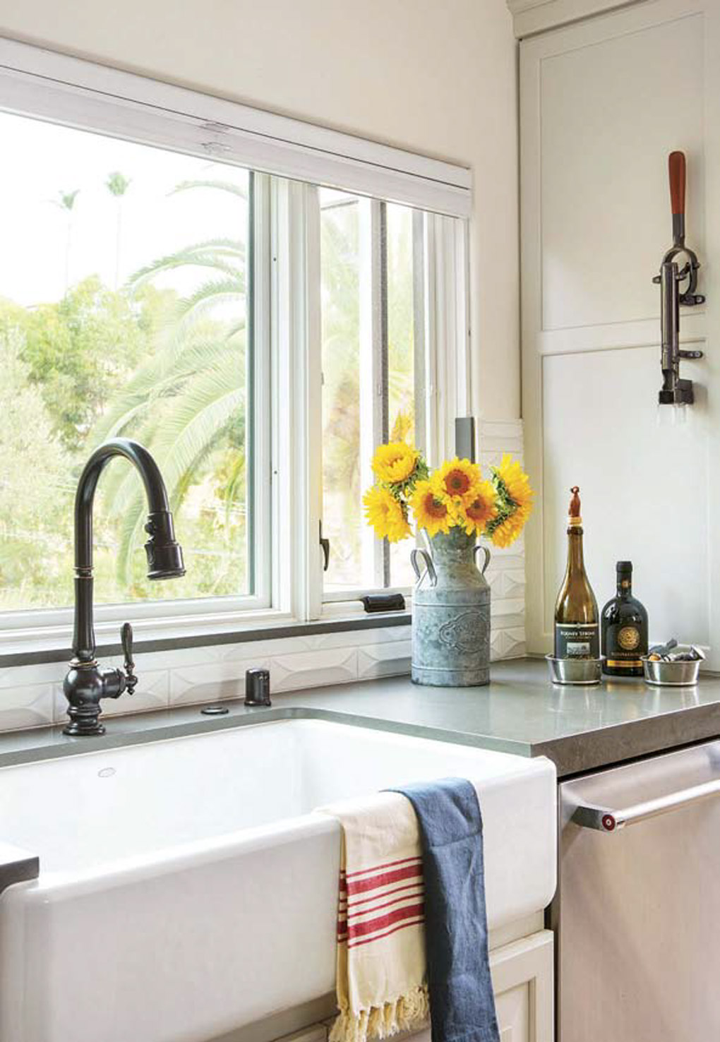 kitchen remodel with beautiful white farmhouse kitchen sink overlooking a large wide window with a view. 