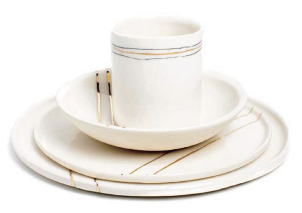 Stacked cream dining set with thin gold accent lines. 