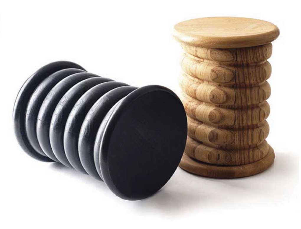 Two Tiffany style stools one in a wool tone and one in black.