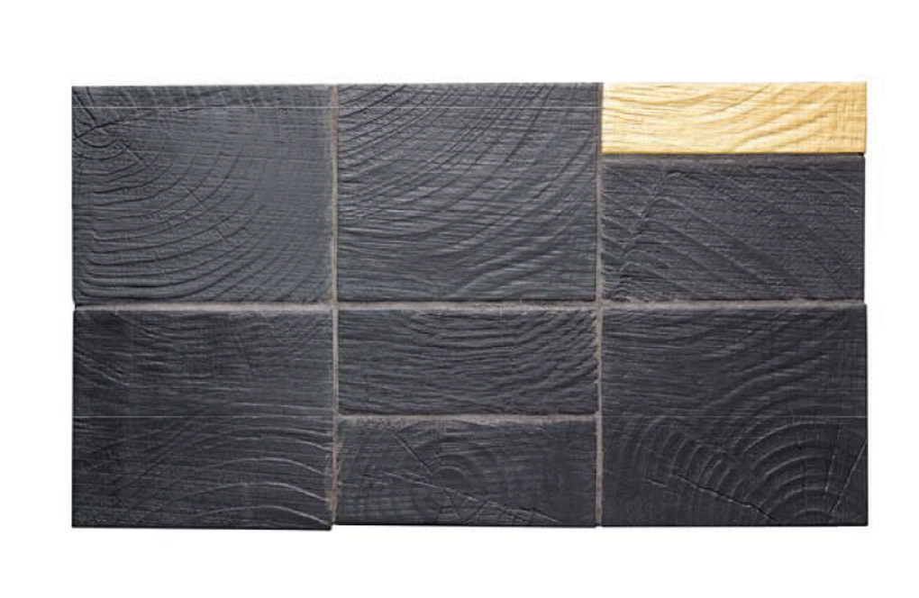 Rustic country style tile sample in a deep gray with woodgrain look.