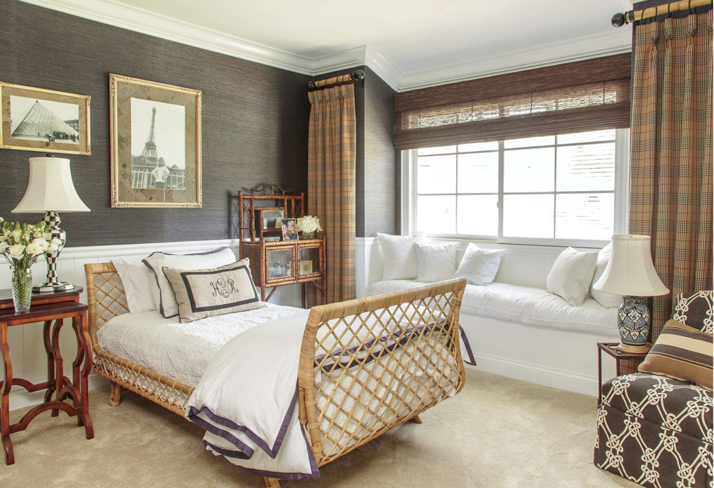 A welcoming home with a guest bedroom with brown deep tones and woven and rattan styled furnishings. 