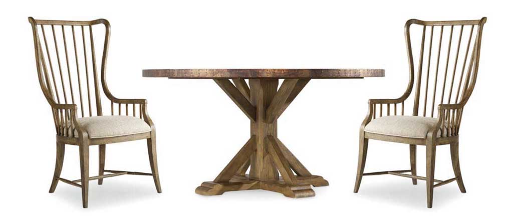 Farmhouse pedestal table and two high-back dining chairs.