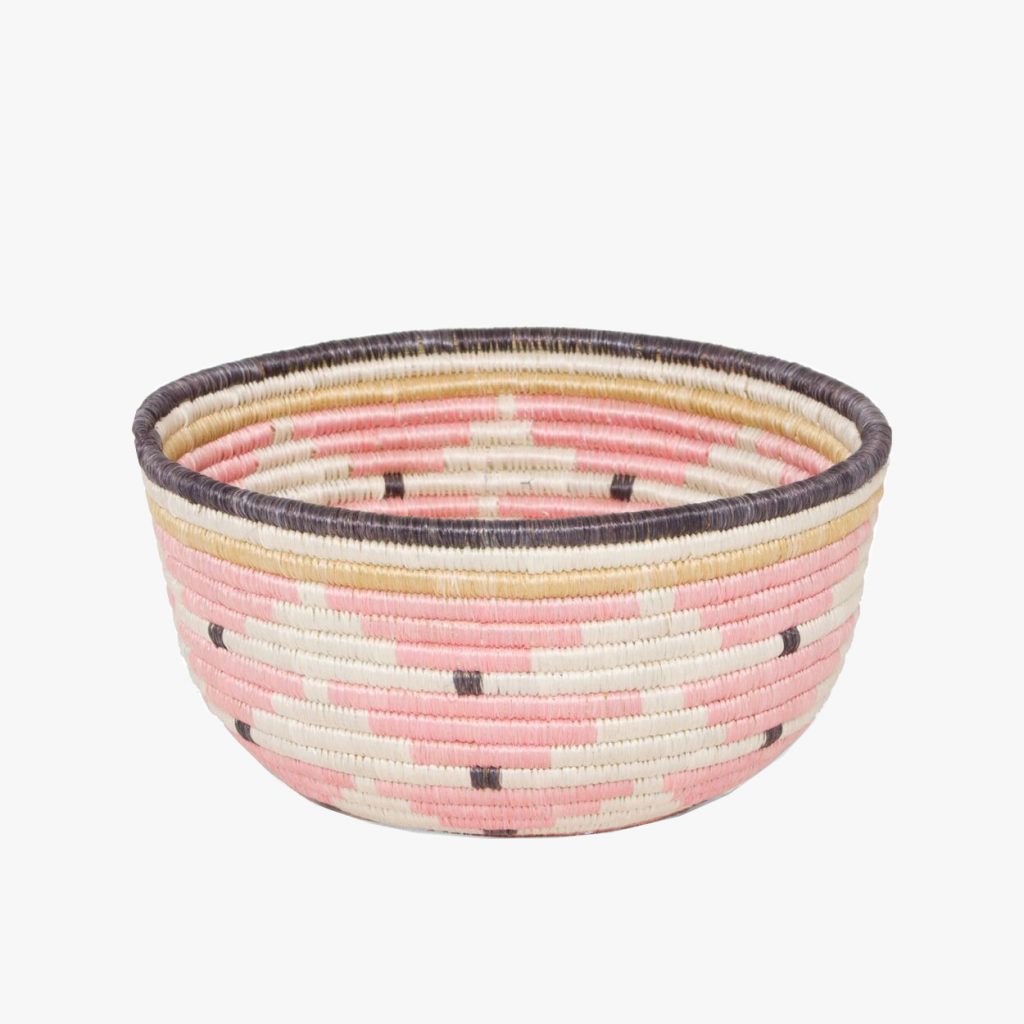 Traditional African woven handmade basket in shades of pink. 