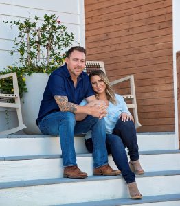 Linsday and JJ Morris on the steps of one of their Scissortail Homes builds.