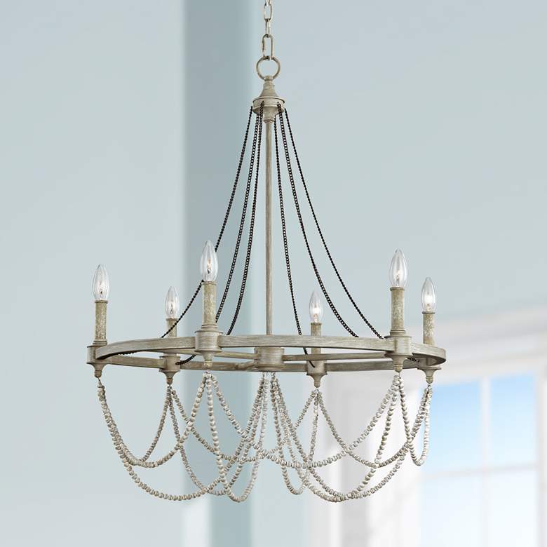 Cottage styled chandelier with exposed bulbs and beaded detailing. 