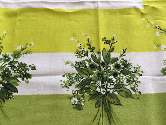 Vintage tablecloth pattern with shades of green and florals. 