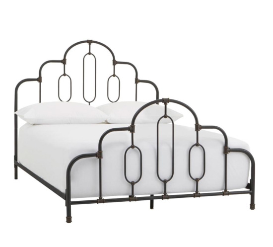 Black metallic Art Deco style bed frame with white bedding. 