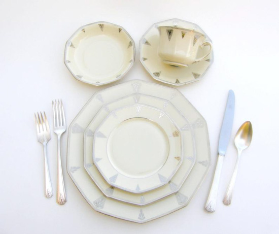 Art Deco dinnerware set in bone cream color with gold and silver accents.