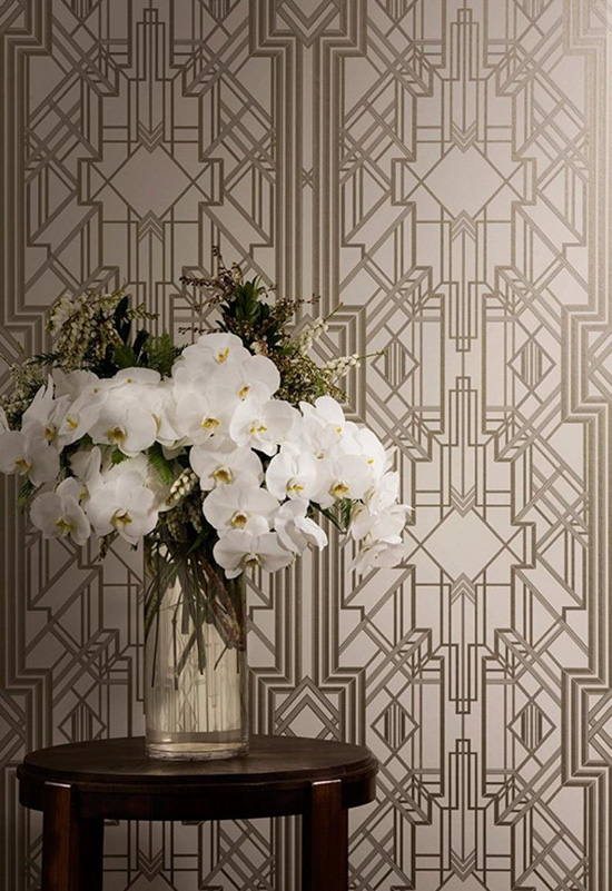 Art Deco metallic foiled wallpaper with a vase of large white flowers.