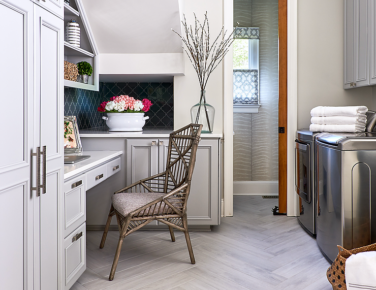 Small home office and laundry room, with white cabinetry and stainless steel appliances.