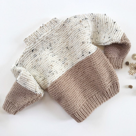 Speckled cream and taupe color blocked kids sweater. 