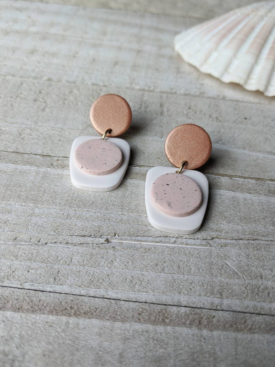 Modern geometric two toned earrings in shades of blush and gold. 