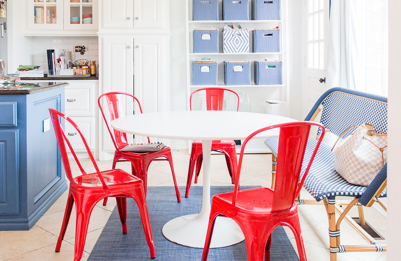 white breakfast table with red tolix chairs and blur accents