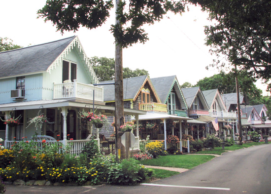 Street view of a colorful line up of cottages in a pocket neighborhood. 