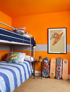 paint color ideas for an orange boys room with aluminum bunk beds and skateboards