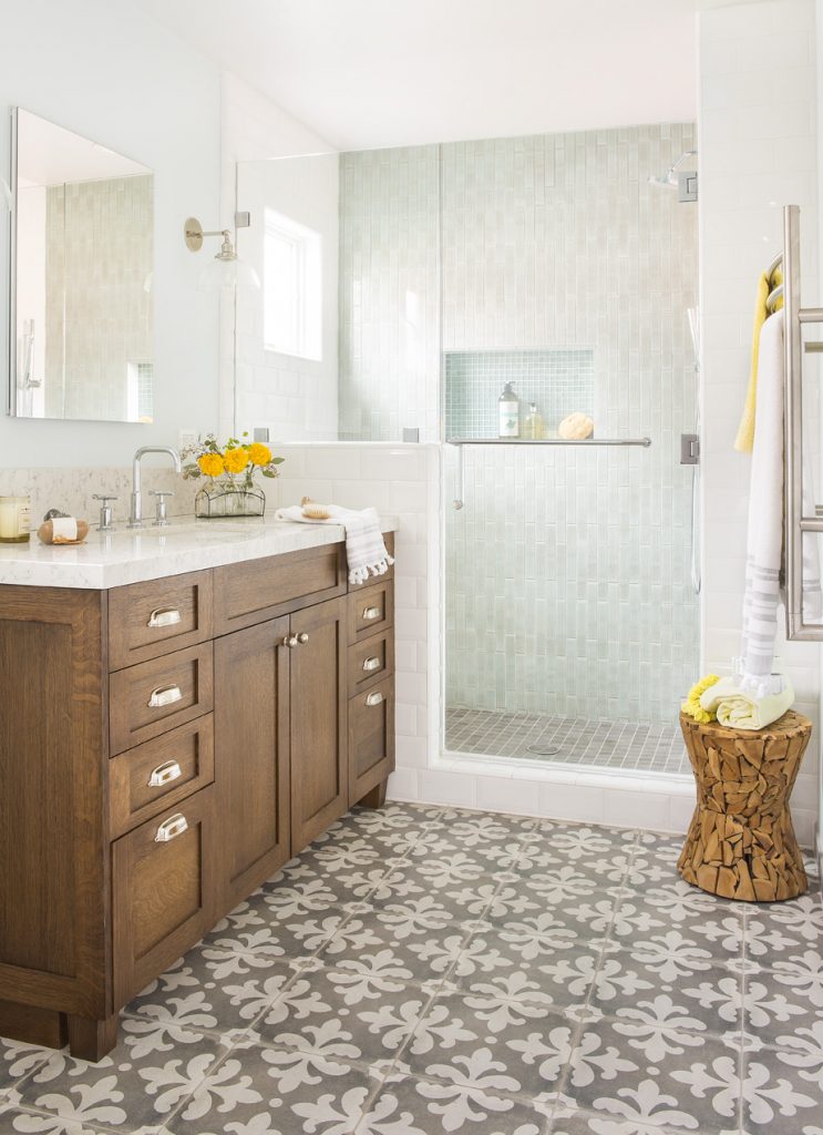 The art of the declutter. In this room master bathroom designed by Jackson Design & Remodeling, the tile choices and the beautiful design of the vanity take center stage over the small odds & ends.