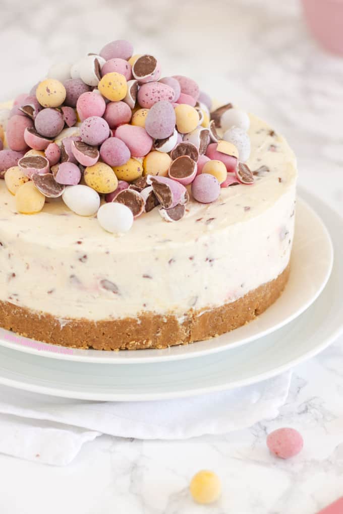 Mini egg cheesecake displayed on white plates a perfect Easter dessert.