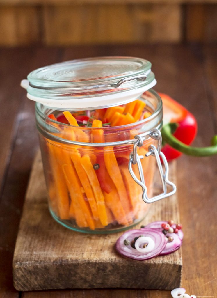 quick pickle carrots in a jar on a cutting board