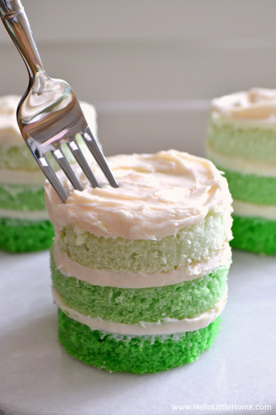 St. Patrick's Day Desserts mini ombre cakes with layers of green cake separated by white frosting. 
