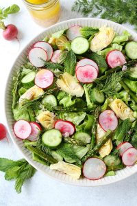 spring cobb salad with artichokes, radish, asparagus fresh dill, and arthichoke hearts