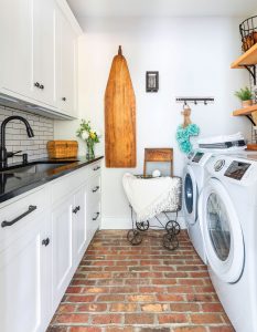 Laundry room with brick floors and subway tile