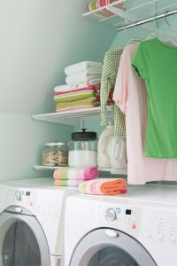 laundry and mudroom design with open shelves above the machines