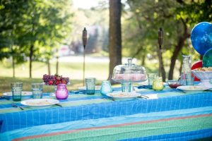 Set of colored glass candles on top of table with party decor