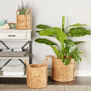 seagrass handled baskets used as planters near a cottage style entry table