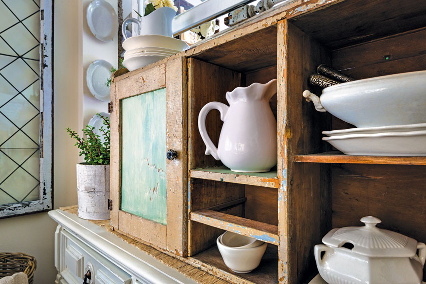 wood cabinet full of ironstone pieces 