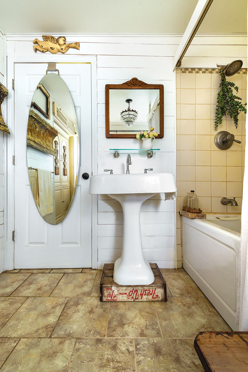 Small bathroom of the a cozy country cottage in white and tan color scheme 